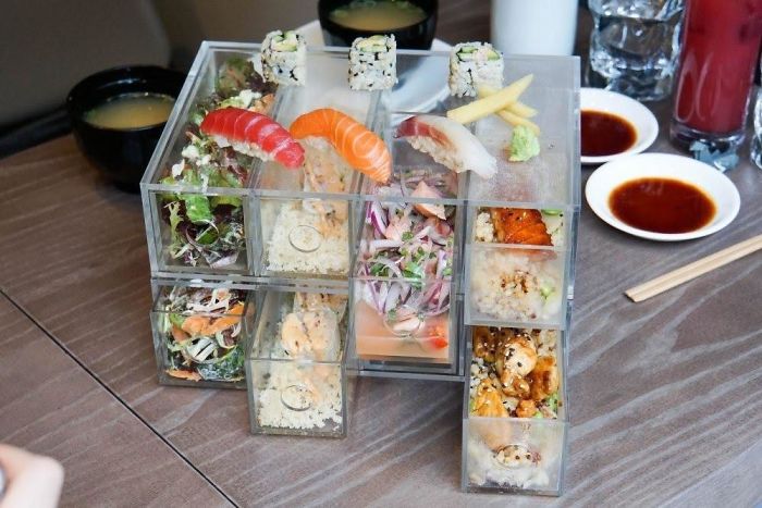 Sushi, Sides And Mains Served In IKEA Style Organisers Because Plates Aren't Orderly Enough And Bento Boxes Are Too Common.