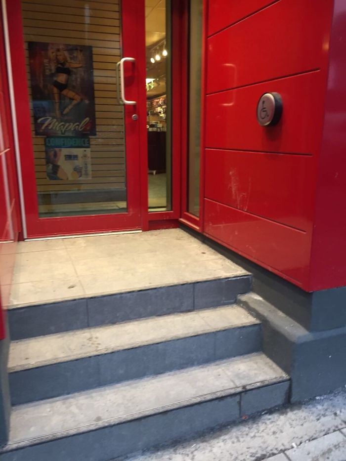 A Wheelchair Access Button On Top Of Staircase