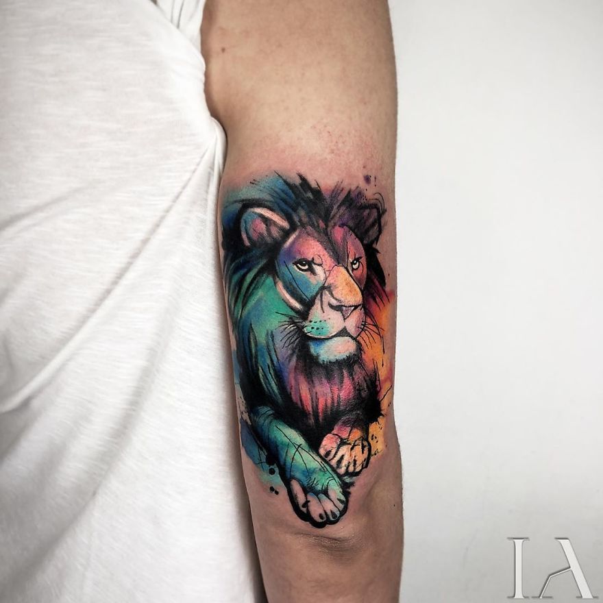 Colorful lion tattoo on arm by Turkish tattoo artist.