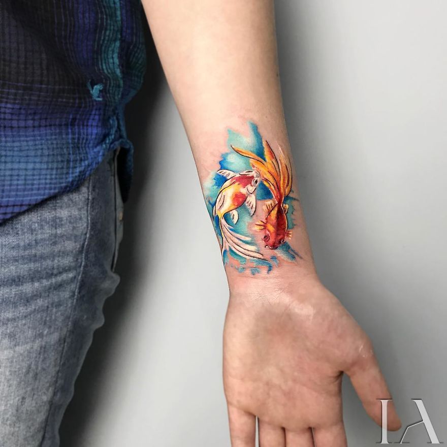 Colorful fish tattoo on forearm by Turkish tattoo artist.