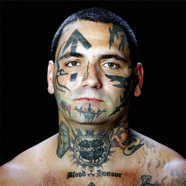 Man with facial and neck tattoos, preparing for removal after becoming a dad, reflecting personal transformation.