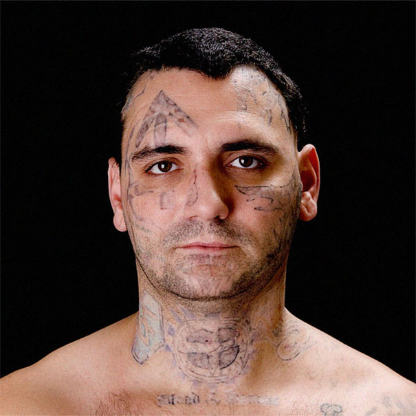Man with facial tattoos on a black background, relevant to skinhead tattoo removal transformation story. Man with facial tattoos on a black background, relevant to skinhead tattoo removal transformation story.