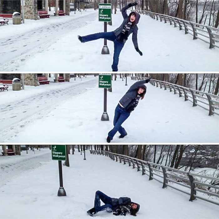 My Wife Mocking The "Slippery When Wet" Sign. I Think The Sign Won