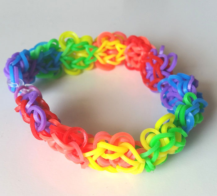 Colorful rubber band bracelet made with interwoven loops, representing one of the hottest trends from the past decade.