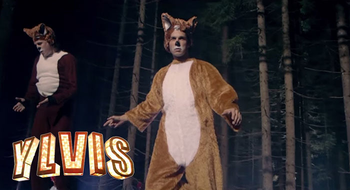 Two people dressed in fox costumes dancing in a dark forest, representing forgotten hottest trends from the past decade.