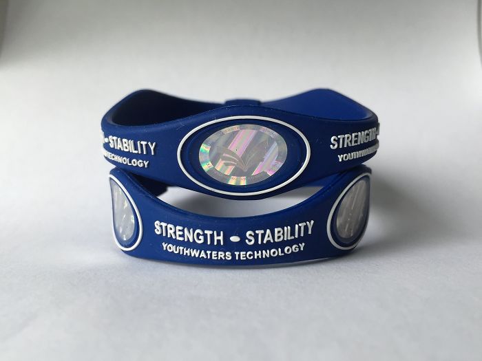Blue strength and stability silicone wristbands with holographic emblem, showcasing popular trends and wearable tech accessories.