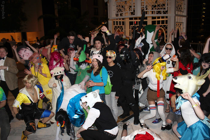 A diverse group of people in colorful costumes at a lively party showcasing forgotten trends from the past decade.