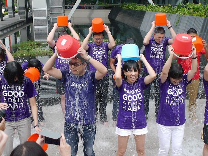 Group of people doing ice bucket challenge outdoors, highlighting popular trends from the past decade forgotten by many.