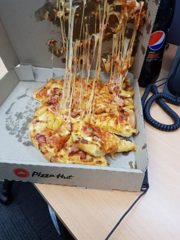 The Delivery Man Delivers Pizzas Under His Arm...