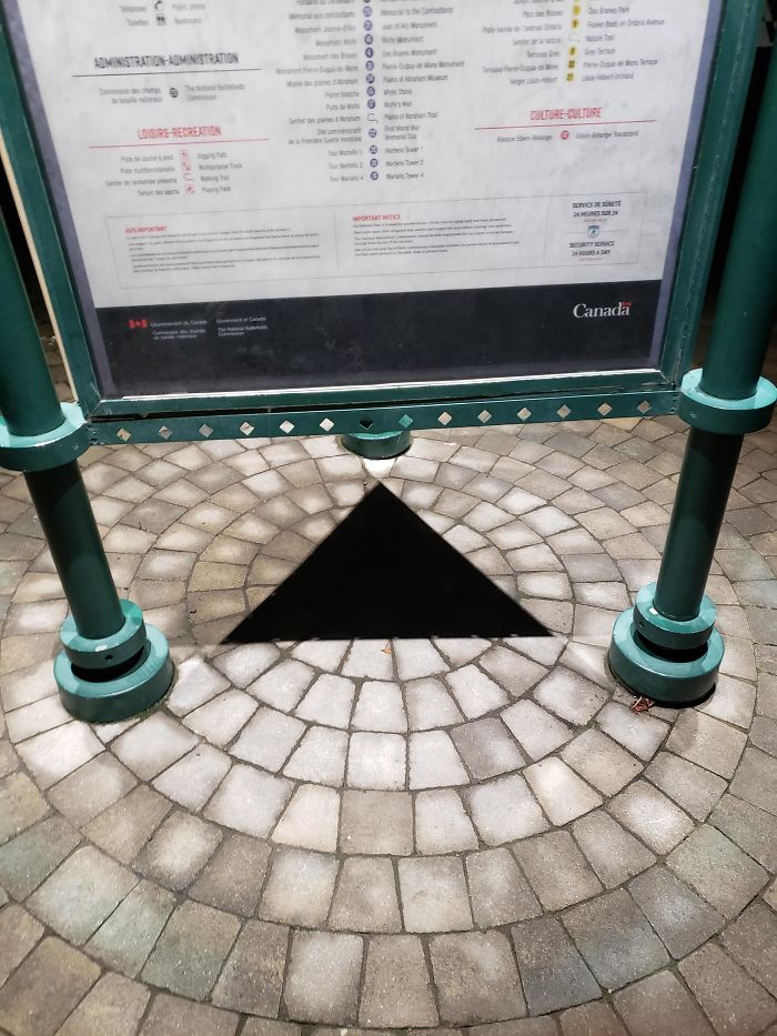 This Triangle Blackhole Created By The Shadow Under An Information Stand