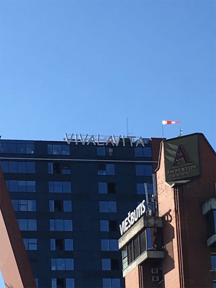 A Restaurant Name In Comic Sans. On A Building. Enjoy