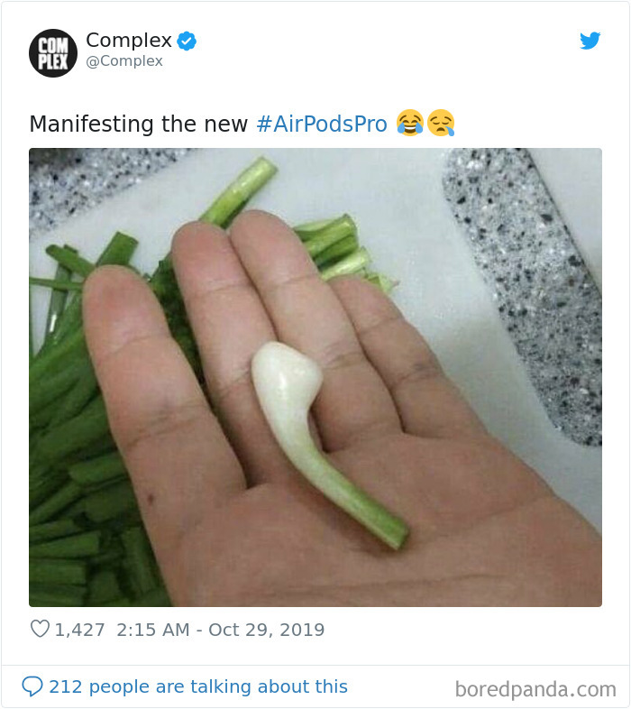 A hand holding a garlic clove resembling AirPods Pro, humorously comparing the two.
