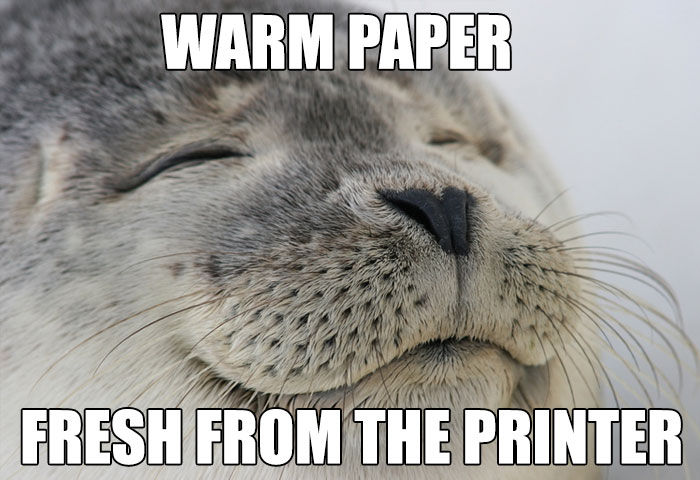 Seal smiling with the text, "Warm paper fresh from the printer," humor meme for freezing office workers.