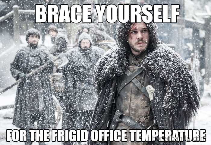 Man in fur coat standing in snow, meme about freezing office temperature.