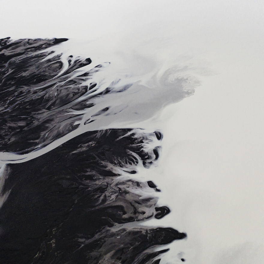 Drone Photo Of Glacial Rivers Cutting Through Black Volcanic Soil