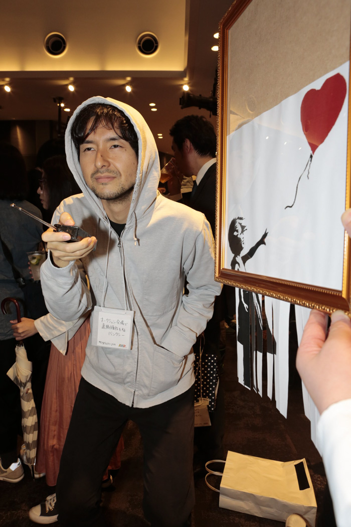 Banksy Turning On The Shredder With A Remote