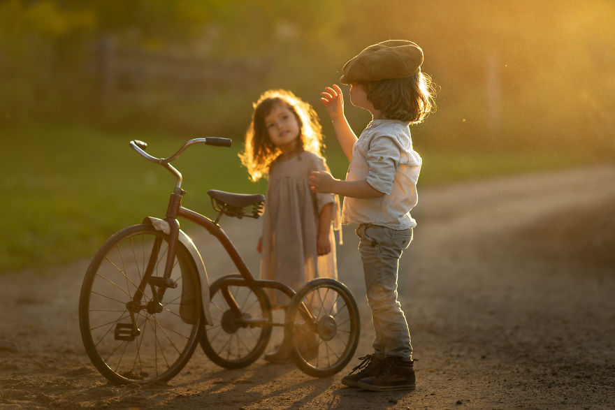 Saint-Paulin, Québec, Canada - Children Playing With A Vintage Tricycle