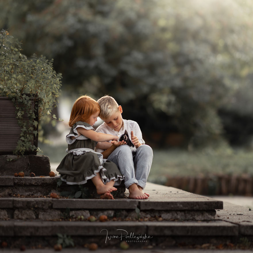 Budakeszi, Hungary - Brother And Sister Playing With Their Kitten