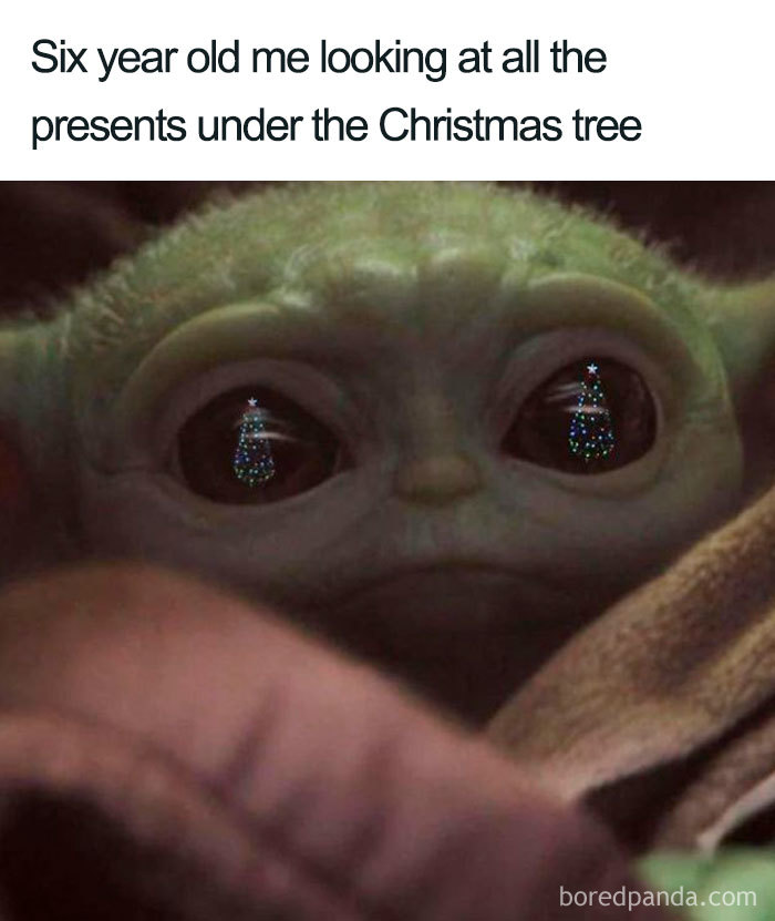 Grogu with Christmas trees in his eyes, capturing the excitement of holiday gifts.