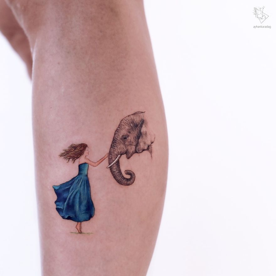 Tattoo design of a girl in a blue dress holding an elephant's trunk, showcasing art on human skin.