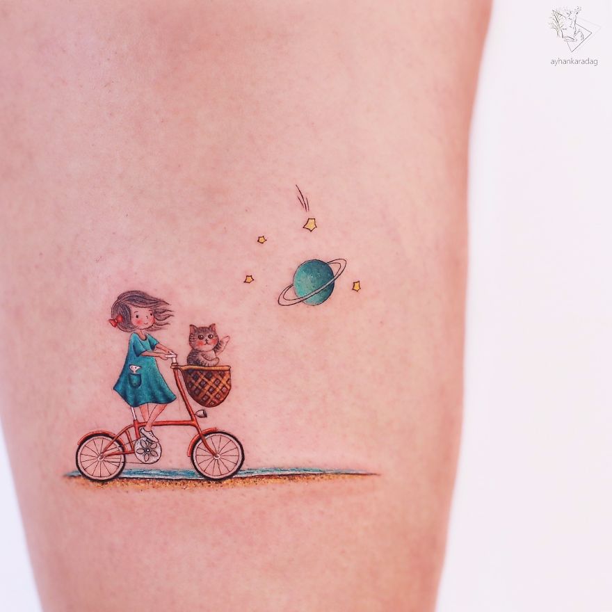 Colorful tattoo design of a girl cycling with a cat under a starry planet sky on human skin.