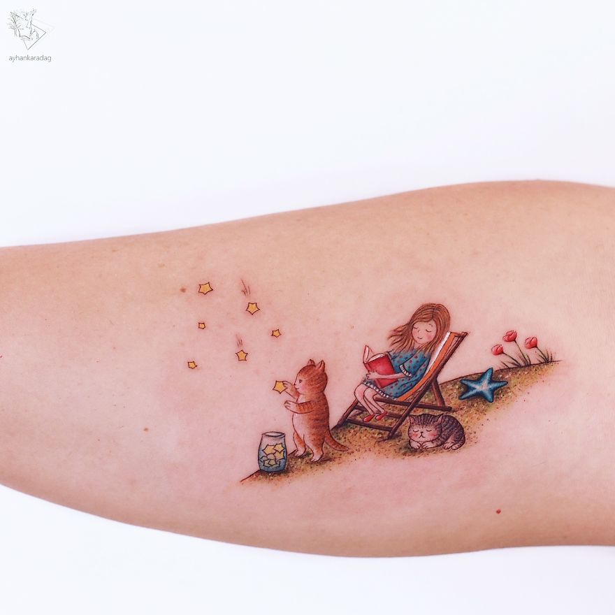 Tattoo design on human skin of a child reading, with a cat and stars nearby.