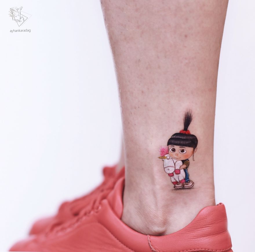 Cute tattoo of a cartoon girl with a unicorn on a person's ankle, showcasing unique tattoo designs on human skin.