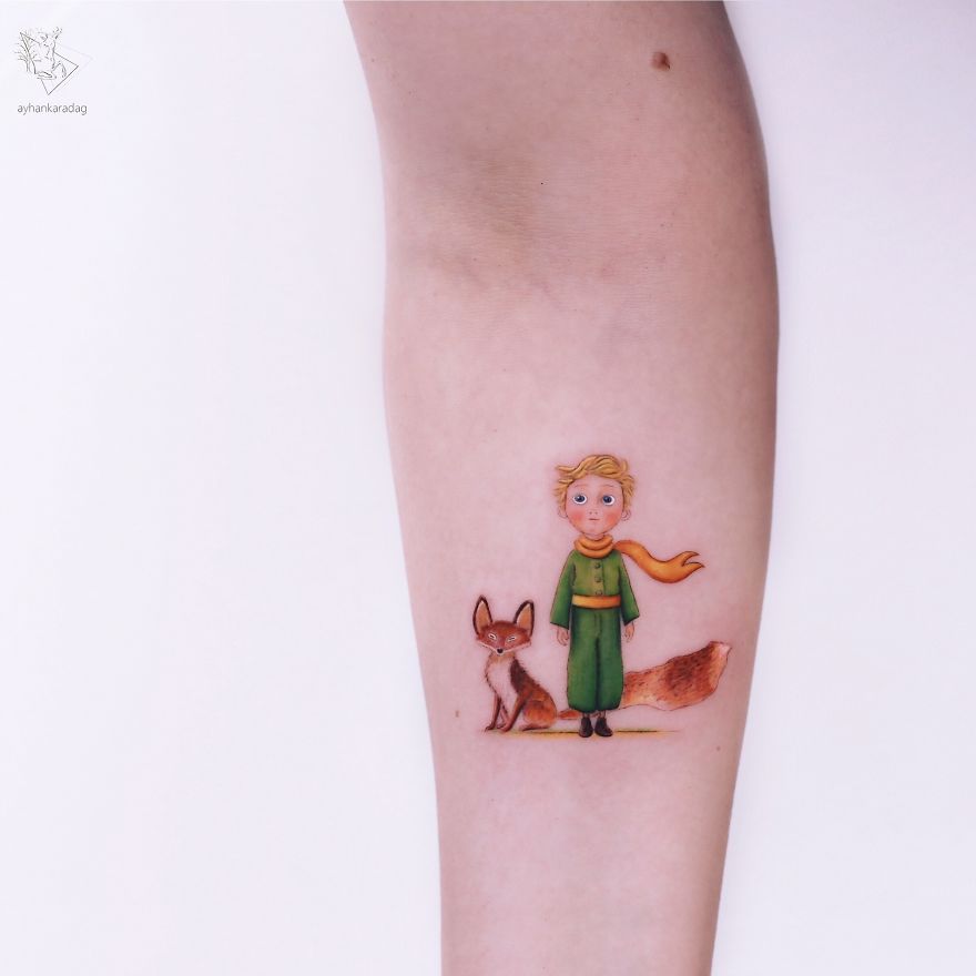 Tattoo design featuring the Little Prince and a fox on human skin, showcasing colorful and detailed artwork.