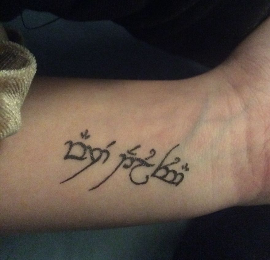 J. R. R. Tolkien inspired tattoo design on a person's forearm.