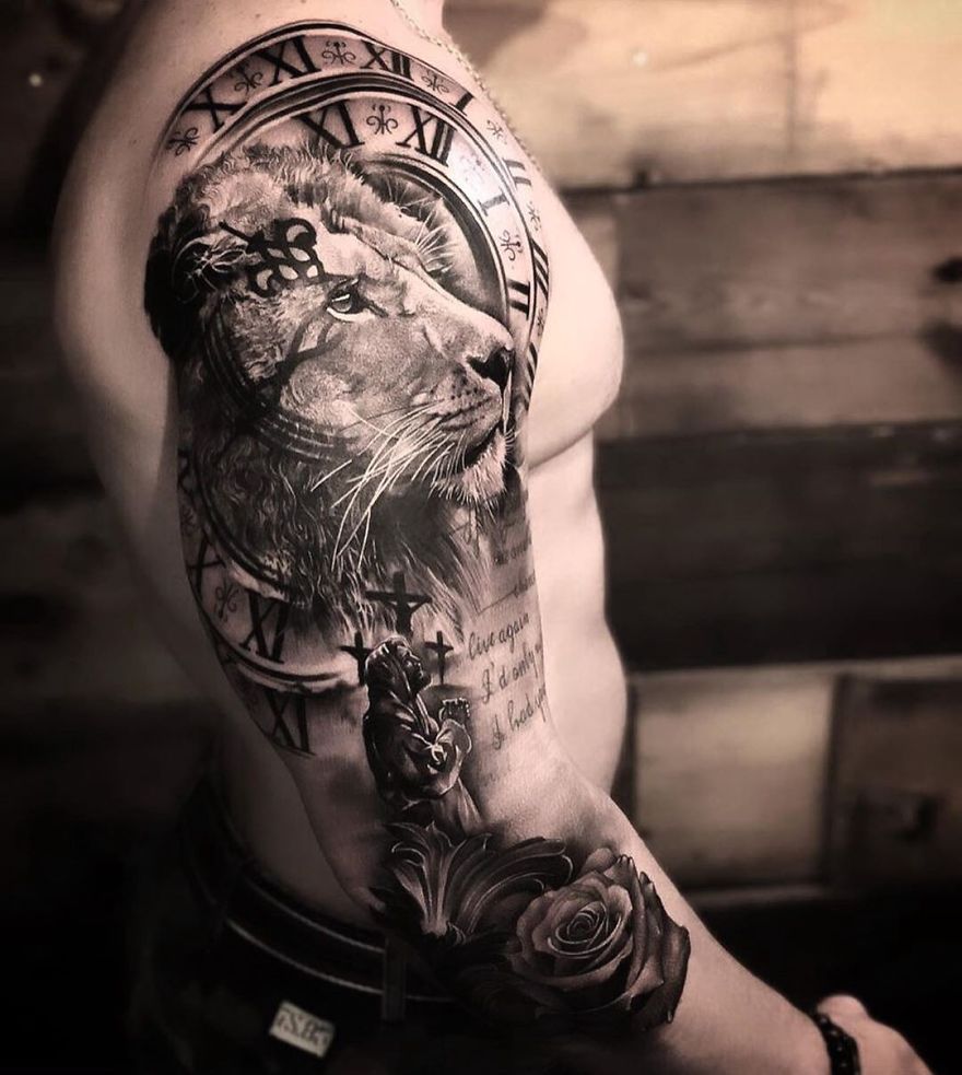 Masculine tattoo with lion, clock, and rose design on a man's arm.