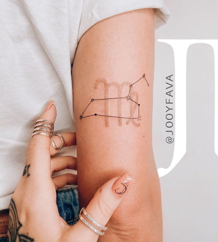 Delicate feminine tattoo of Virgo constellation on an arm, styled with rings and a manicure showing moon design.