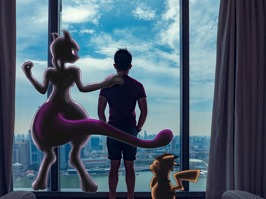 Man in a room with Pokémon illustrations of Mewtwo and Pikachu overlooking a cityscape.