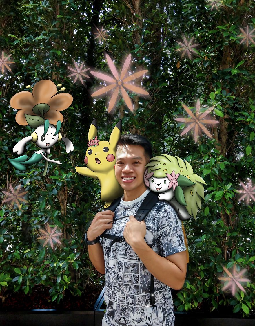 Man posing with Pokémon illustrations in a garden setting, smiling and surrounded by colorful characters.
