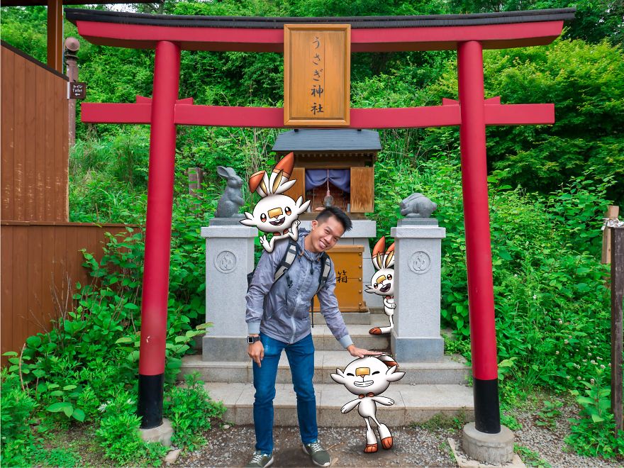 Person with Pokémon illustrations at a Japanese shrine gate, smiling with cartoon characters.
