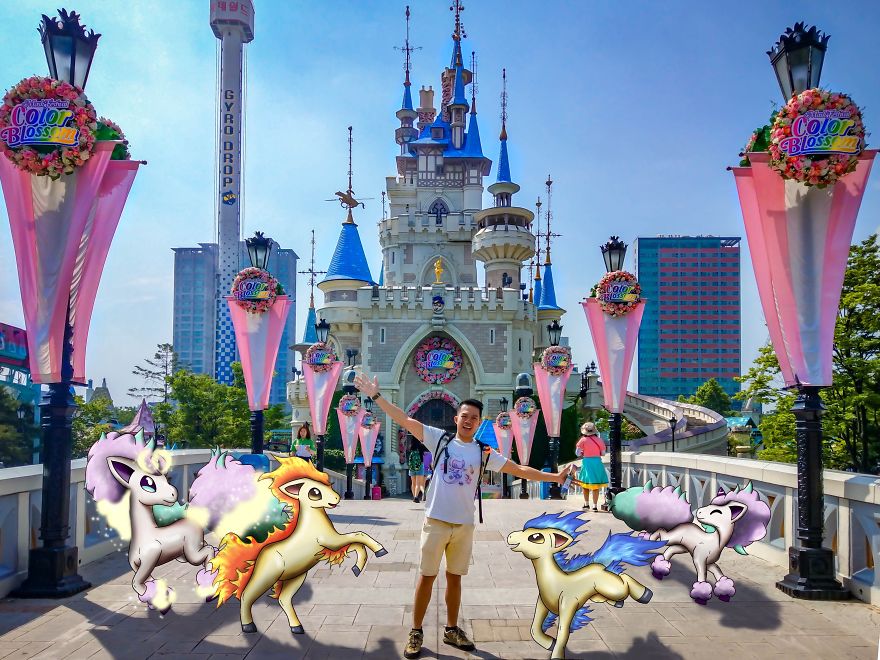 Person posing with Pokémon illustrations in front of a colorful castle.