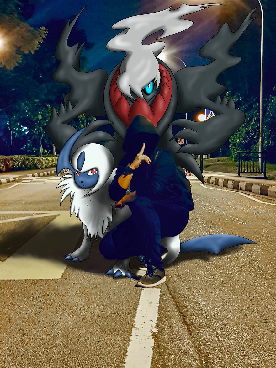 Person squatting in the street with Pokémon illustrations, featuring a dark creature and a white, wolf-like character at night.