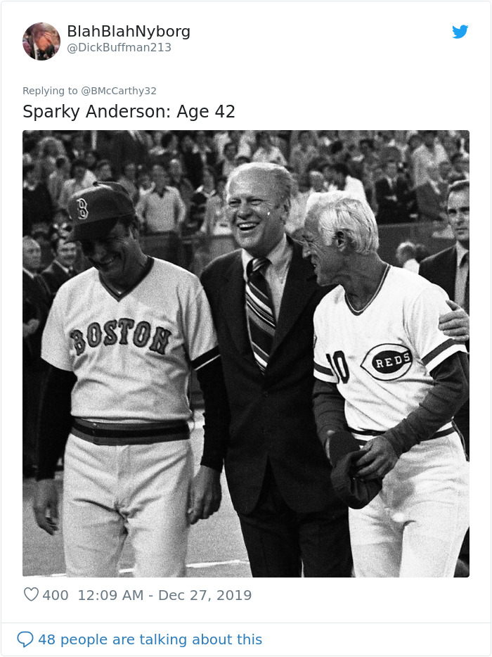Black and white photo of three men, two in vintage baseball uniforms, illustrating humans aged faster in the past.