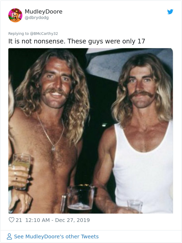 Two young men with long hair and mustaches holding drinks, illustrating how humans aged faster in the past.