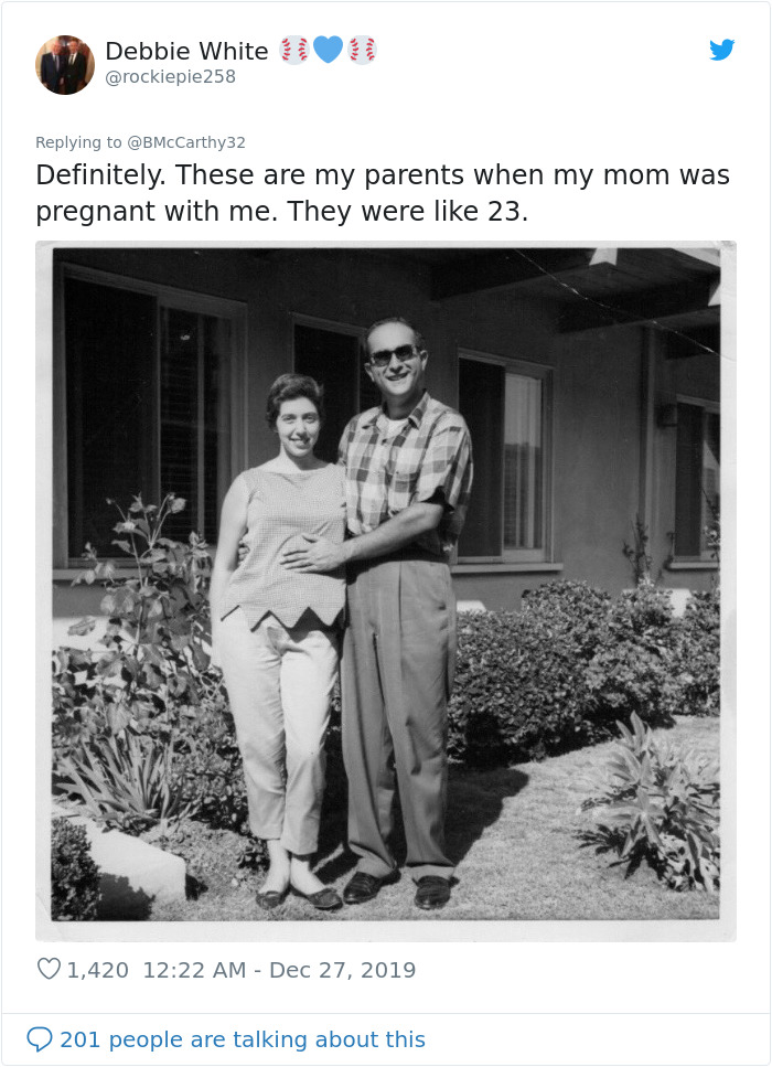 Black and white old photo of a smiling young couple outside their home, illustrating humans aged faster in the past. Black and white old photo of a smiling young couple outside their home, illustrating humans aged faster in the past.