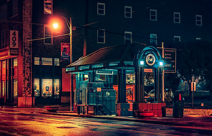 Bus stop illuminated at night in a scene from one of the most dangerous cities in America, showcasing urban street details.
