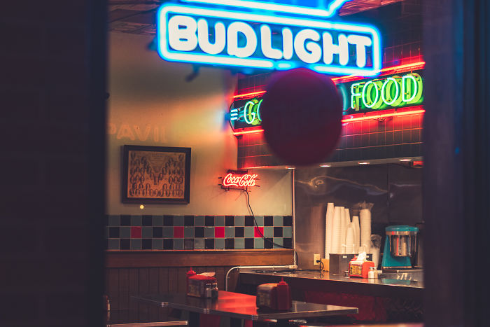 Neon signs glowing inside a small diner in one of the most dangerous cities in America at night.