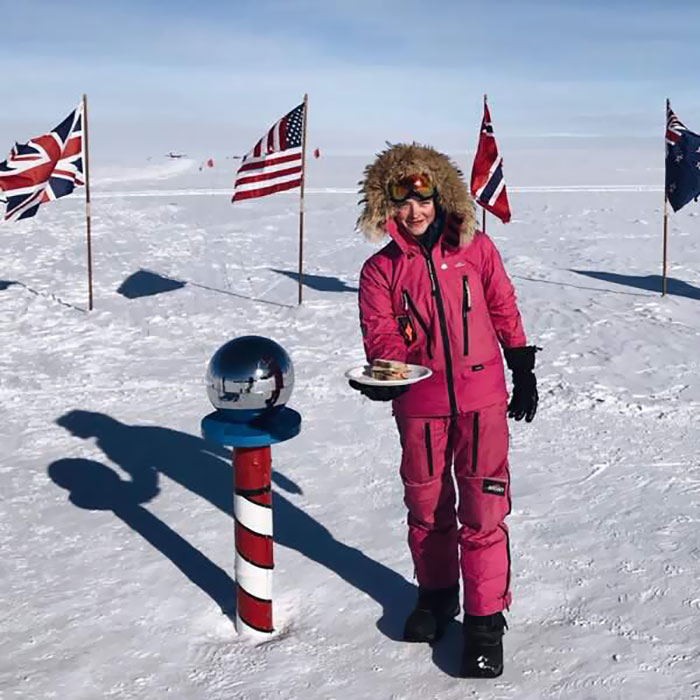 Woman holding a plate of food in the north pole 