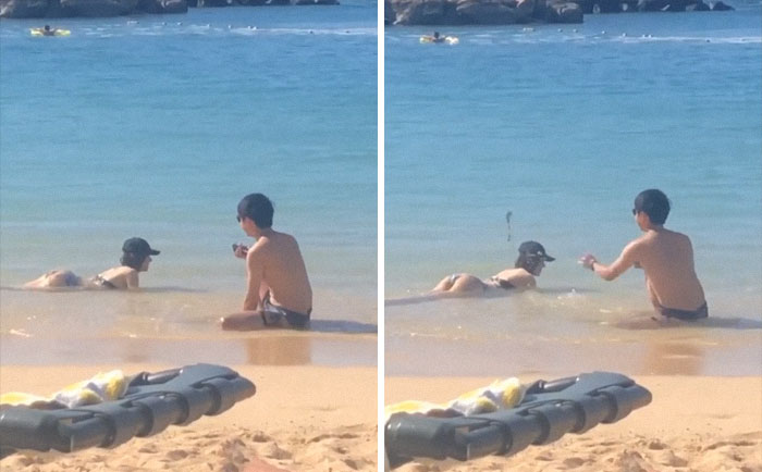 Woman posing in water while her boyfriend is taking a picture 