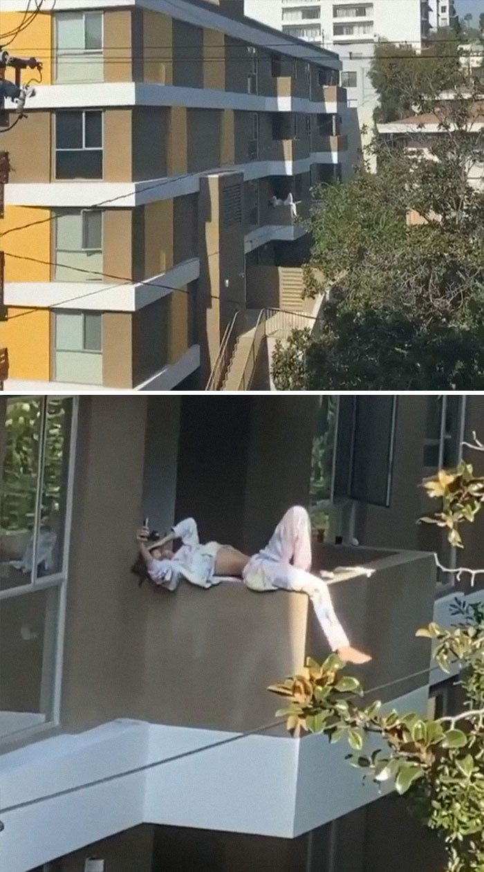 Woman posing on the edge of the balcony 