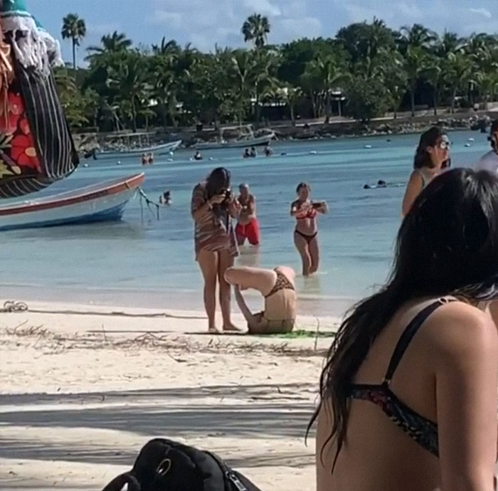 Girl taking picture of her friend in a weird position 