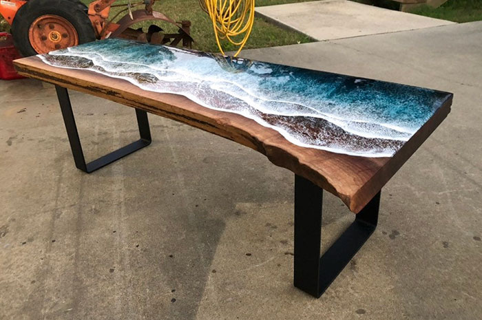 These Artists Create Mesmerizing Tables That Look Like They're Being Washed By An Ocean Wave