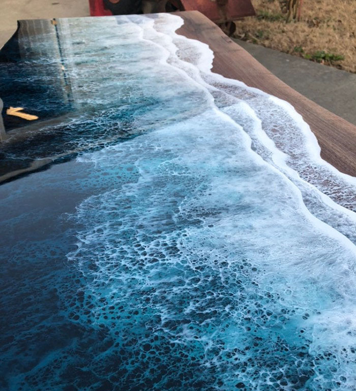 These Artists Create Mesmerizing Tables That Look Like They're Being Washed By An Ocean Wave