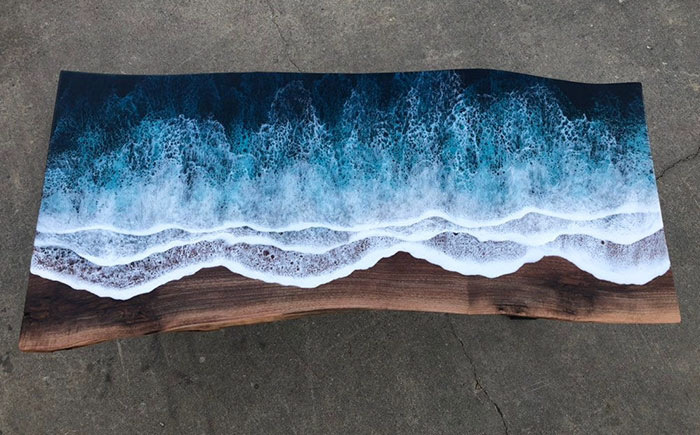 These Artists Create Mesmerizing Tables That Look Like They're Being Washed By An Ocean Wave