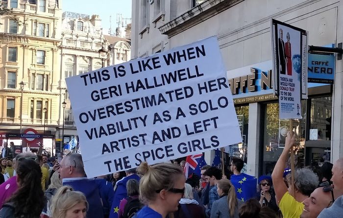 People in a crowd holding a sign comparing Brexit to Geri Halliwell leaving the Spice Girls.