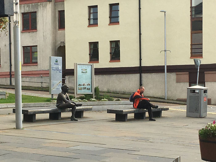 Found This Man Sitting In Front Of A Statue In Scotland